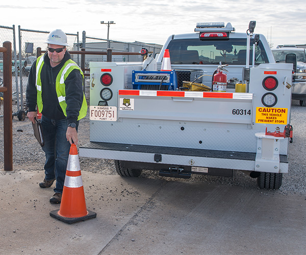 kansas gas service truck employee placing cone